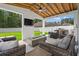 Relaxing covered patio with comfortable seating, a built-in grill, a TV, and a cozy fire pit at 405 Spring View Ct., Little River, SC 29566