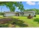 Expansive backyard featuring a well-maintained lawn and mature trees for outdoor enjoyment at 4249 E Highway 9, Loris, SC 29569