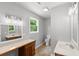 Bright bathroom featuring a vanity with a built-in makeup counter and an additional white ceramic sink at 4249 E Highway 9, Loris, SC 29569