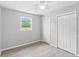 Light-filled bedroom with ceiling fan, wood-look flooring, window, and double closets at 4249 E Highway 9, Loris, SC 29569
