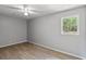 Bedroom with a ceiling fan, wood-look floors and natural light from an exterior window at 4249 E Highway 9, Loris, SC 29569