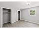 Bedroom with ceiling fan, window with view and open closets with closet rods at 4249 E Highway 9, Loris, SC 29569