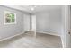 Well-lit bedroom featuring wood-look floors, a window, and a view into another room at 4249 E Highway 9, Loris, SC 29569