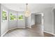 Open dining room with gray walls, modern vinyl floors, a gorgeous light fixture, and lots of natural light at 4249 E Highway 9, Loris, SC 29569
