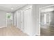 Hallway with three white closet doors and neutral tile, creating a clean and organized space at 4249 E Highway 9, Loris, SC 29569