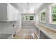 Functional laundry room boasts ample cabinet space, bright windows, and a convenient countertop at 4249 E Highway 9, Loris, SC 29569