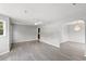 Bright living room featuring gray walls, modern vinyl floors, and elegant light fixture at 4249 E Highway 9, Loris, SC 29569