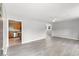Spacious living room featuring gray walls and modern vinyl floors leading to the kitchen at 4249 E Highway 9, Loris, SC 29569