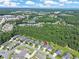 Aerial view of a residential neighborhood with trees, a pond, and the ocean in the distance at 428 Arlington Circle, Murrells Inlet, SC 29576