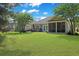 A lush, green backyard with a home featuring a screened porch and outdoor patio at 428 Arlington Circle, Murrells Inlet, SC 29576