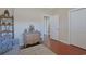 Bright bedroom features a decorative dresser, wood floors, shelving unit, and soothing neutral paint at 428 Arlington Circle, Murrells Inlet, SC 29576