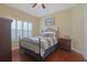 Neutral bedroom with tray ceiling, shuttered windows, and a decorative metal frame bed at 428 Arlington Circle, Murrells Inlet, SC 29576