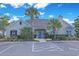 Front view of a light stone clubhouse with well-maintained landscaping and parking at 428 Arlington Circle, Murrells Inlet, SC 29576