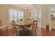 Dining room with an elegant chandelier, hardwood floors, and lots of natural light at 428 Arlington Circle, Murrells Inlet, SC 29576