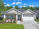 Charming single-story home with a well-manicured lawn, two-car garage and inviting front porch at 428 Arlington Circle, Murrells Inlet, SC 29576