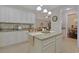 Functional kitchen with white cabinets, granite counters, a center island, and modern lighting fixtures at 428 Arlington Circle, Murrells Inlet, SC 29576
