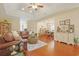 Comfortable living room with hardwood flooring, decorative accents, and a seamless view to the dining space at 428 Arlington Circle, Murrells Inlet, SC 29576