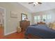 Primary bedroom with hardwood floors, tray ceilings, and bright natural light at 428 Arlington Circle, Murrells Inlet, SC 29576