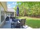 A backyard patio with a table, grill, and lush, green surroundings at 428 Arlington Circle, Murrells Inlet, SC 29576