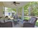 Relaxing screened porch features comfortable wicker furniture and a peaceful view of the backyard at 428 Arlington Circle, Murrells Inlet, SC 29576