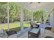 Relaxing screened porch features wicker furniture and a view of the lush green backyard at 428 Arlington Circle, Murrells Inlet, SC 29576