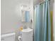 This bathroom has a single vanity, a shower with a turquoise curtain, and a standard toilet at 4325 Ellis Ave., Little River, SC 29566