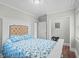 This bedroom features wood floors, a closet, and a large headboard with light blue ocean-themed bedding at 4325 Ellis Ave., Little River, SC 29566