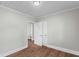 This bedroom has a closet, neutral walls, wood flooring, and white painted trim at 4325 Ellis Ave., Little River, SC 29566
