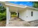This carport features white brick columns, a wood fence, and an entrance to the house at 4325 Ellis Ave., Little River, SC 29566