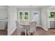 Bright dining area with modern table and chairs and windows at 4325 Ellis Ave., Little River, SC 29566