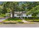 Charming single-story brick home with a well-manicured lawn, mature trees, and inviting curb appeal at 4325 Ellis Ave., Little River, SC 29566