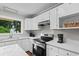 Bright kitchen with white cabinets, countertop, and stainless steel appliances providing modern style at 4325 Ellis Ave., Little River, SC 29566