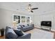 Bright living room with large windows, neutral walls, hardwood floors and modern ceiling fan at 4325 Ellis Ave., Little River, SC 29566