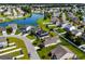 Aerial view of a home with a lake, neighborhood pool, and surrounding homes at 445 Mooreland Dr., Myrtle Beach, SC 29588