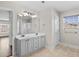 Bathroom with gray vanity, double sink, light fixture, and glass shower at 445 Mooreland Dr., Myrtle Beach, SC 29588