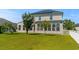 Back exterior of home with solar panels features a lawn with green grass at 445 Mooreland Dr., Myrtle Beach, SC 29588