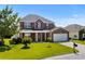 Charming two-story brick home featuring a well-manicured lawn and an attached two-car garage at 445 Mooreland Dr., Myrtle Beach, SC 29588