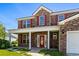 Charming front porch with brick facade, decorative columns, and a vibrant red front door at 445 Mooreland Dr., Myrtle Beach, SC 29588