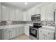 Modern kitchen featuring stainless steel appliances, granite countertops, and ample storage at 445 Mooreland Dr., Myrtle Beach, SC 29588