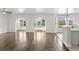 Open-concept living room with hardwood floors, arched doorways, and large windows at 445 Mooreland Dr., Myrtle Beach, SC 29588