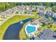 Aerial view of the community pool, clubhouse, and surrounding residences on a sunny day at 447 Mahogany Dr. # 102, Murrells Inlet, SC 29576
