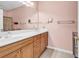 Bright bathroom featuring a double sink vanity with wood cabinets at 447 Mahogany Dr. # 102, Murrells Inlet, SC 29576