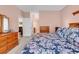 Cozy bedroom featuring floral bedding, wooden dressers, and soft pink walls at 447 Mahogany Dr. # 102, Murrells Inlet, SC 29576