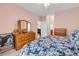 Bedroom with pink walls, light carpet, and wooden dresser at 447 Mahogany Dr. # 102, Murrells Inlet, SC 29576