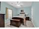 Bedroom with blue walls, neutral bedding, and chest at the foot of the bed at 447 Mahogany Dr. # 102, Murrells Inlet, SC 29576