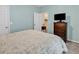 Comfortable bedroom with blue walls and an open door to another room at 447 Mahogany Dr. # 102, Murrells Inlet, SC 29576