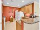 A bright kitchen featuring wooden cabinets, granite countertops, and a refrigerator at 447 Mahogany Dr. # 102, Murrells Inlet, SC 29576