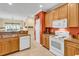 Charming kitchen with granite countertops, wooden cabinets, and modern appliances at 447 Mahogany Dr. # 102, Murrells Inlet, SC 29576