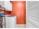 Laundry room with orange walls, a washer, dryer, and storage space at 447 Mahogany Dr. # 102, Murrells Inlet, SC 29576