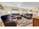 Large living room with hardwood floors, comfortable seating, and windows providing ample natural light at 447 Mahogany Dr. # 102, Murrells Inlet, SC 29576